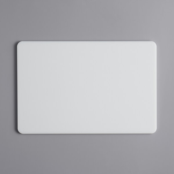 A white rectangular Tomlinson Chef's Edge cutting board.