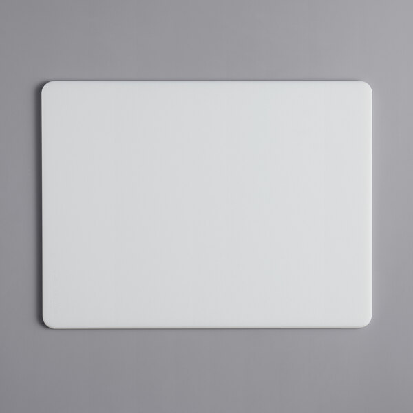 A white rectangular Tomlinson Chef's Edge cutting board with a black border.