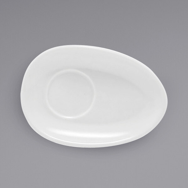 A white oval porcelain saucer.