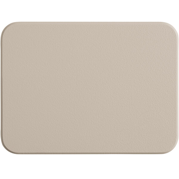 A beige rectangular Tomlinson Chef's Edge cutting board with rounded corners on a white surface.