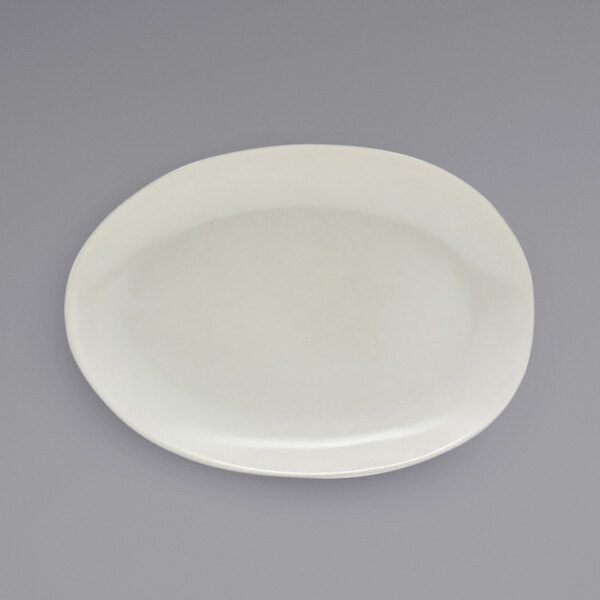 A white plate with a scallop oval shape on it.