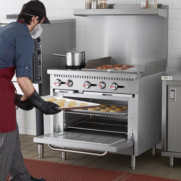 Cooking Performance Group S60-G36-N Natural Gas 4 Burner 60 Range with 36  Griddle and 2 Standard Ovens - 240,000 BTU