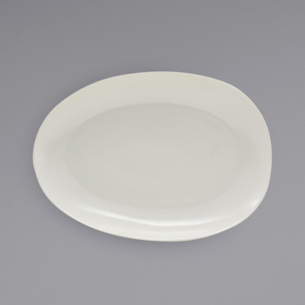 A white Front of the House Tides semi-matte scallop oval porcelain plate.
