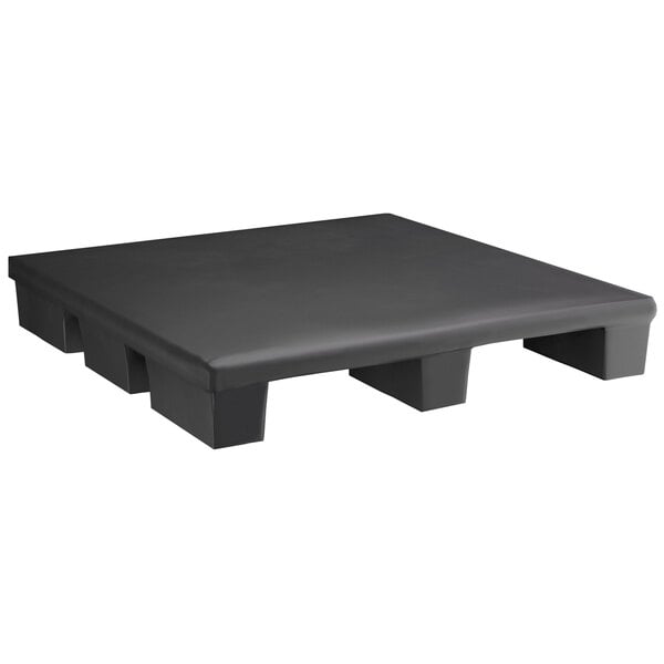 A Regency black plastic pallet base with legs on a table.