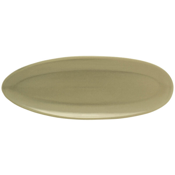 A close-up of a beige oval porcelain plate with a semi-matte finish.