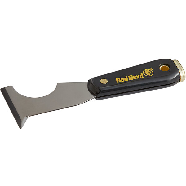 A Red Devil Pro Series Zip-A-Way multi-purpose paint tool with a black and gold knife with a nylon handle.