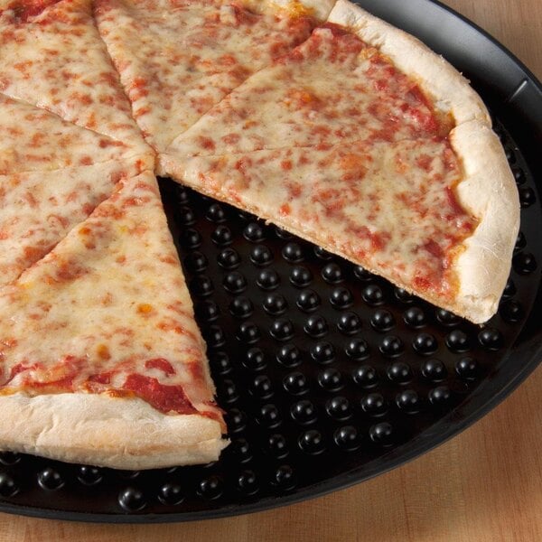 A cheese pizza on a black HS Inc. pizza tray with a slice missing.