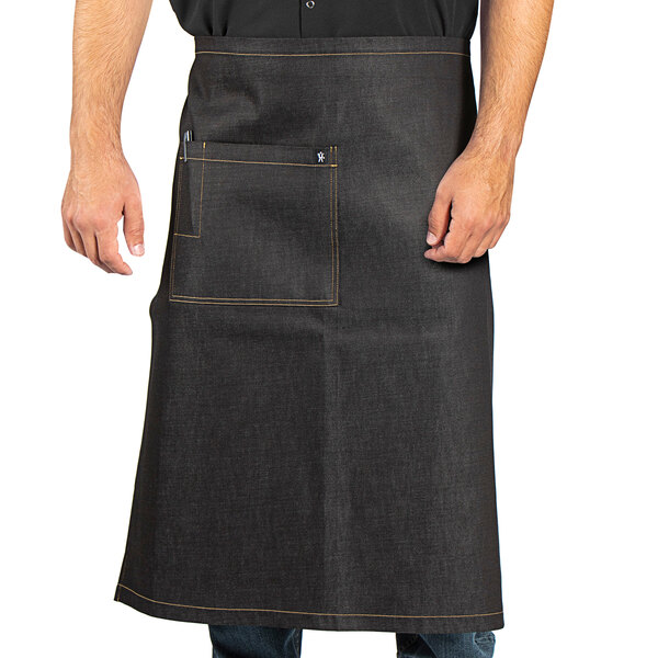 A man wearing a black denim Uptown Bistro apron with black webbing.