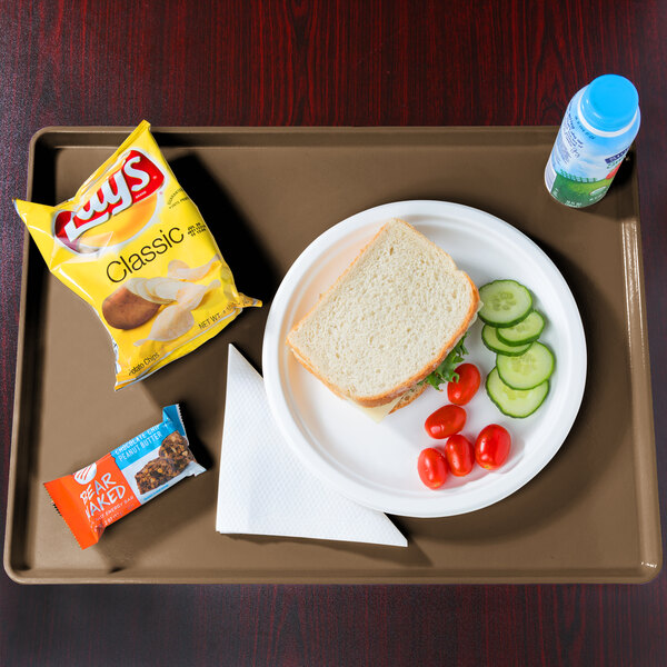 A Cambro dietary tray with a sandwich, vegetables, and a drink on it.