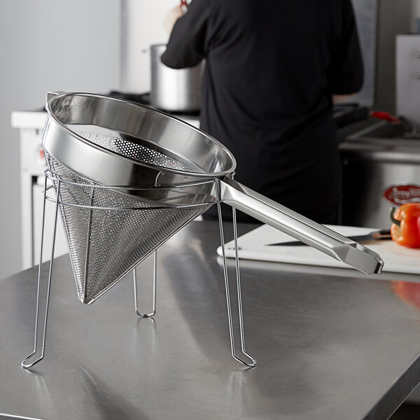 A stainless steel Choice Fine China Cap Strainer on a counter.