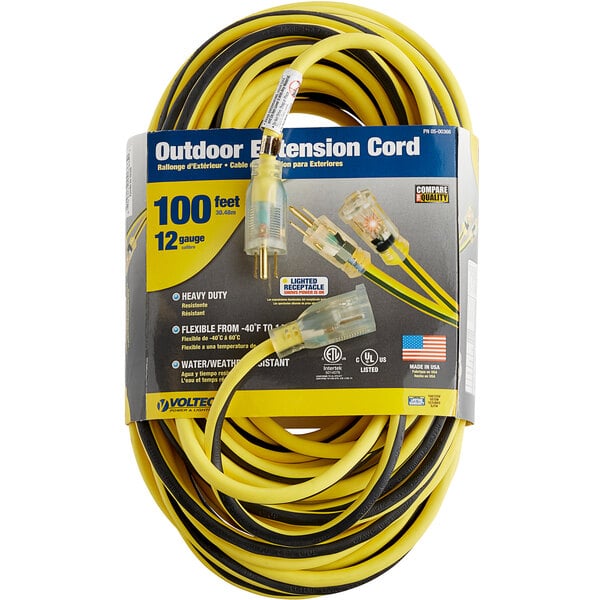 A close up of a yellow and black Voltec 3-conductor extension cord.