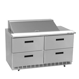 A Delfield stainless steel refrigerator with four drawers on a counter.