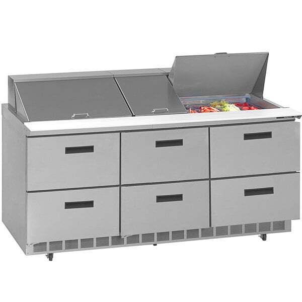 A Delfield stainless steel refrigerated sandwich prep table with drawers.