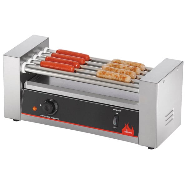 A Vollrath hot dog grill with hot dogs cooking on it.