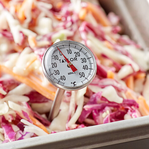 A Taylor 6094N instant read pocket probe dial thermometer in a bowl of coleslaw.
