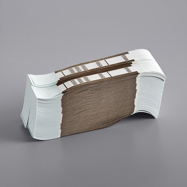 A stack of brown paper money straps with white labels.