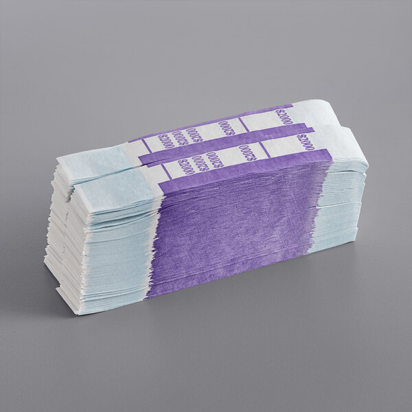 A stack of purple and white paper money straps.