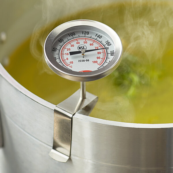 A Cooper-Atkins instant read probe thermometer in a pot of soup.