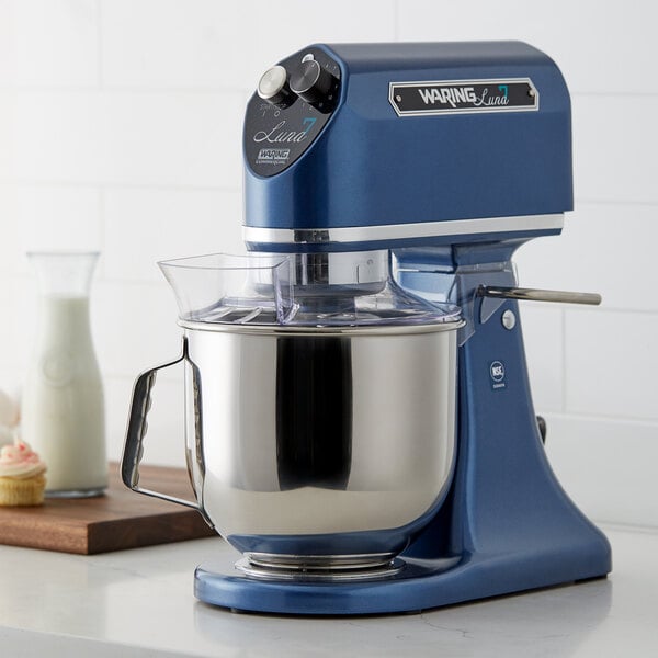 A blue Waring countertop mixer with a bowl on top.