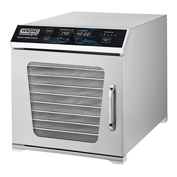 A silver Waring food dehydrator with a digital display and a door on a school kitchen counter.