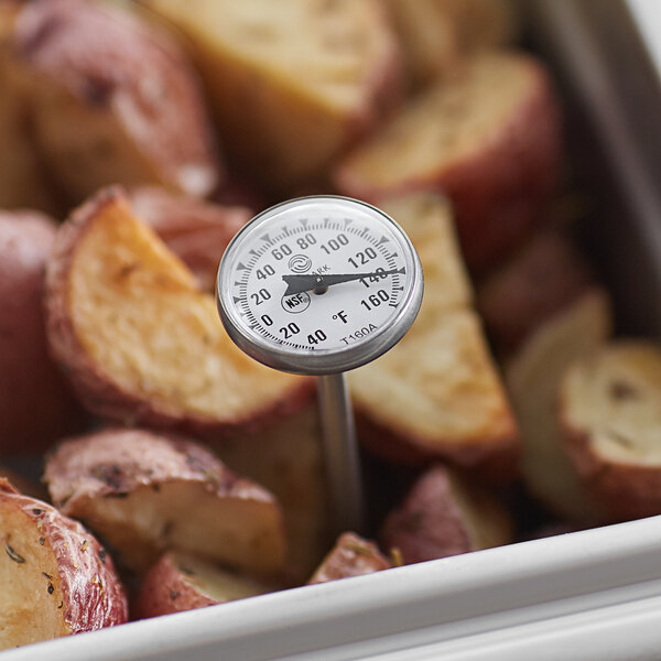A Comark pocket probe thermometer in a container of potatoes.