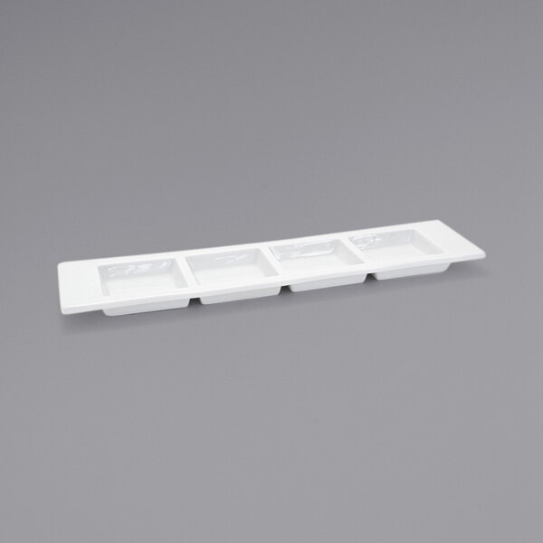 A white rectangular porcelain tray with four compartments.