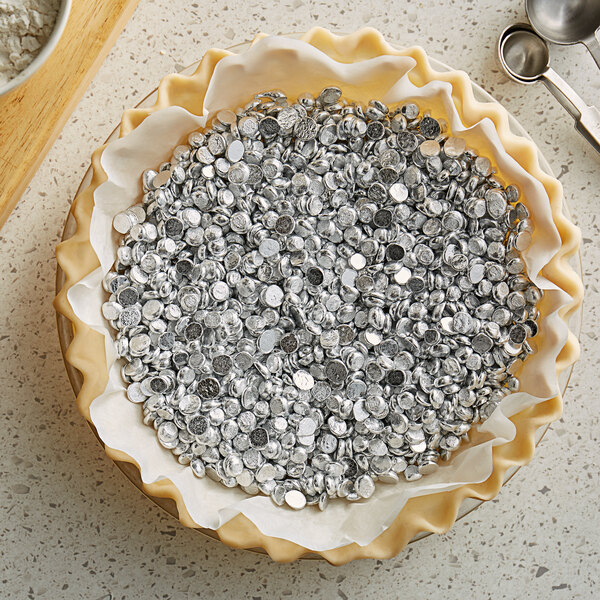 A pie crust filled with Matfer Bourgeat aluminum pie weights.