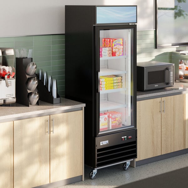 A black swing glass door merchandiser freezer with LED lighting, stocked with frozen food items and positioned between countertops in a commercial setting.