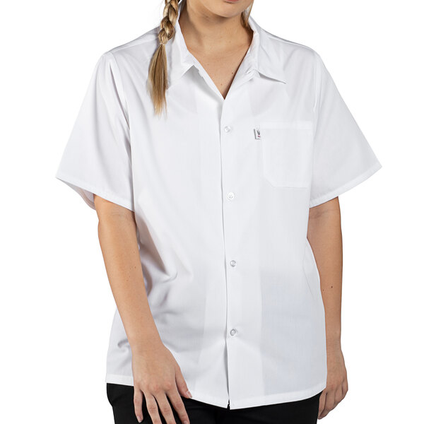 A woman wearing a Uncommon Chef white short sleeve cook shirt.