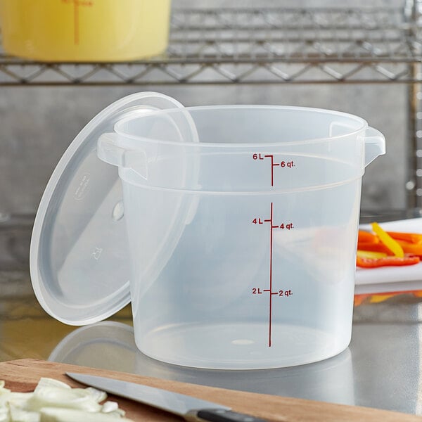 A Cambro translucent plastic food storage container with a lid and measuring cup.