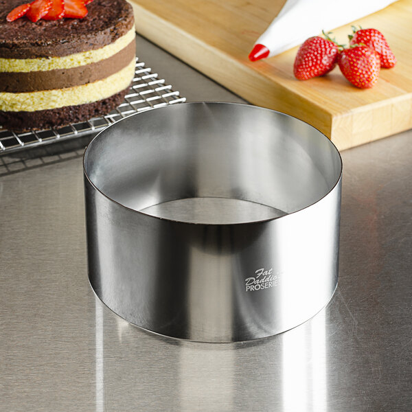 A cake baked in a Fat Daddio's stainless steel round cake ring with strawberries on top.