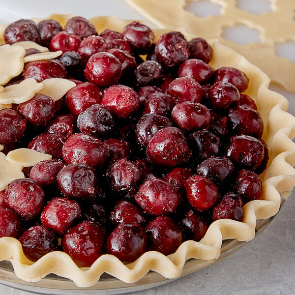 A pie with 26.5 lb. IQF dark sweet pitted cherries on top.