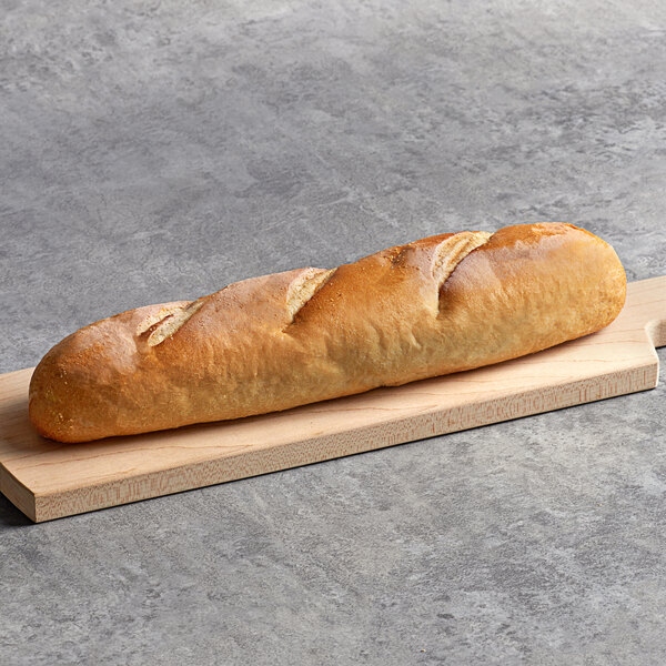 An Amoroso's unsliced hoagie roll on a wooden cutting board.