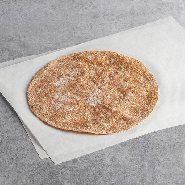 A Father Sam's Bakery whole wheat tortilla on a white surface.