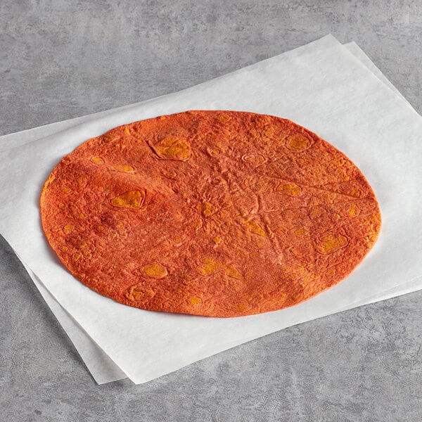A Father Sam's Bakery sundried tomato tortilla on a white paper.