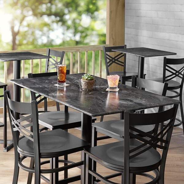 A Lancaster Table with chairs and drinks on it.