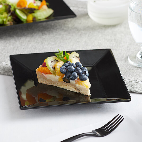 A slice of fruit pie on a black Acopa Rittenhouse square plate.