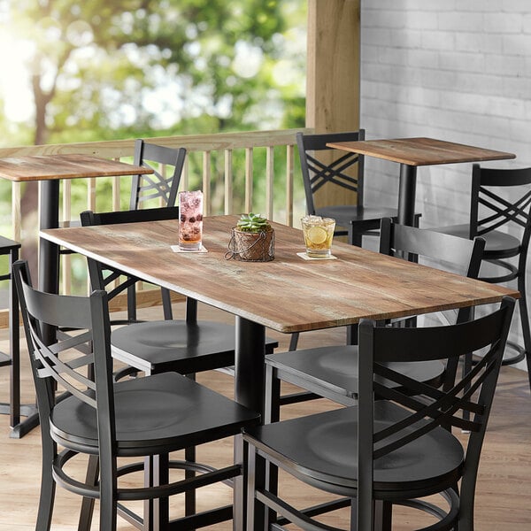 A Lancaster Table with Chairs and a Plant on It.