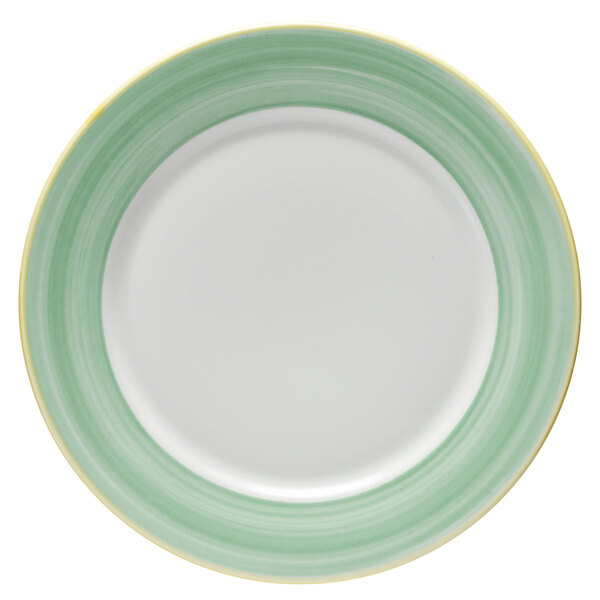 A bright white porcelain plate with a green and yellow rim.