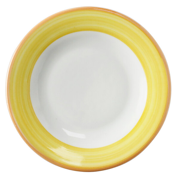 A close-up of a Corona bright white porcelain plate with a yellow and coral rim.