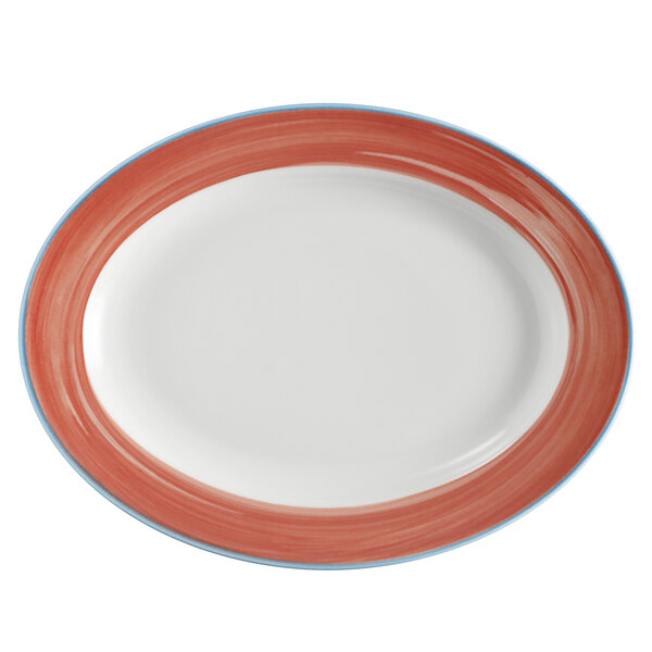 A white oval platter with a red and blue rim decorated with coral and blue designs.