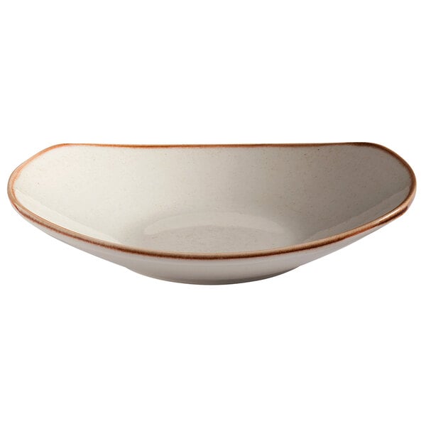 A beige oval porcelain bowl with a brown rim.
