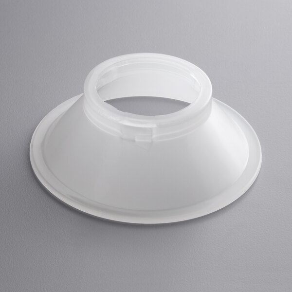 A white plastic flange with a hole and a white plastic cone with a hole.