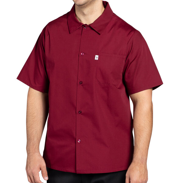 A man wearing a burgundy Uncommon Chef cook shirt.
