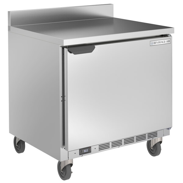 A Beverage-Air stainless steel worktop refrigerator on wheels with a door.