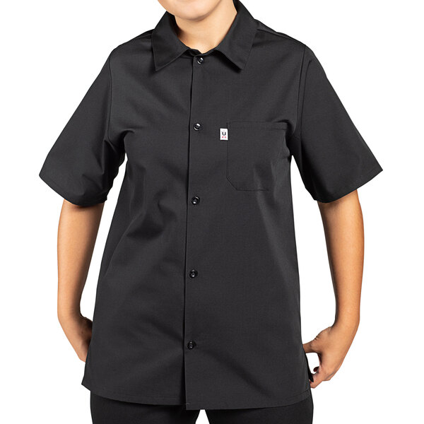 A person wearing a black Uncommon Chef cook shirt.