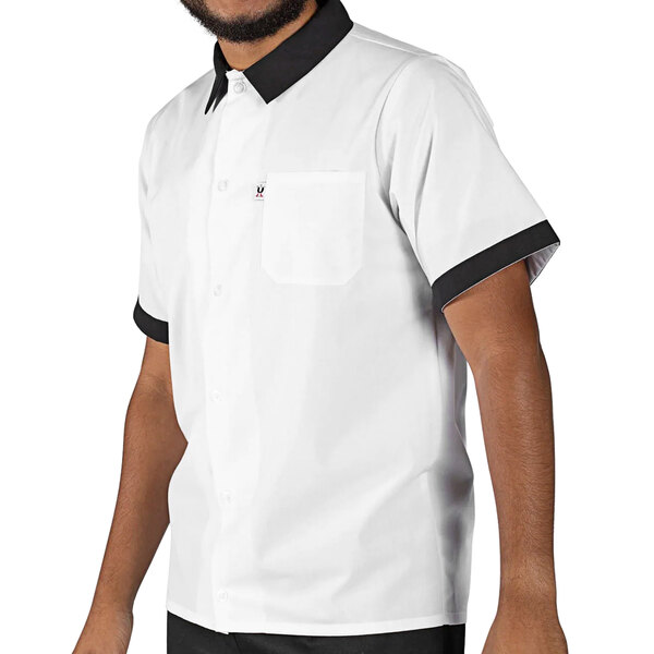 A man wearing a white Uncommon Chef cook shirt with black trim.