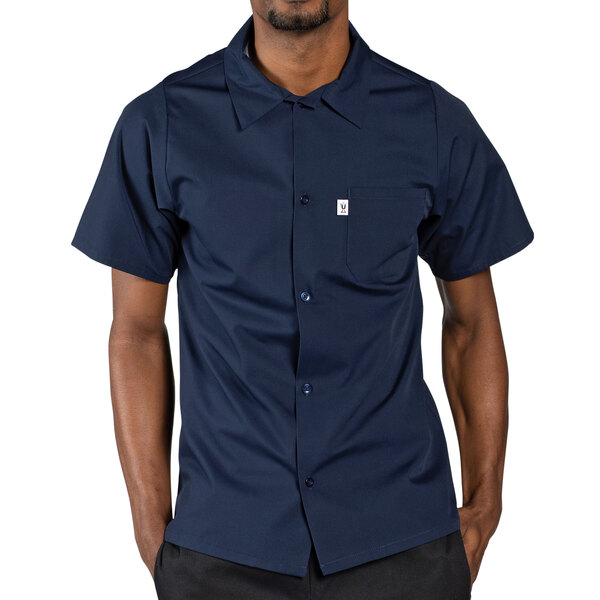 A man wearing a navy Uncommon Chef classic short sleeve cook shirt.
