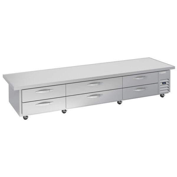 A Beverage-Air stainless steel chef base with six drawers on a long white rectangular table.