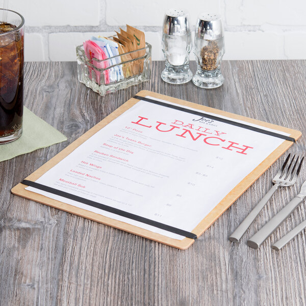 A natural wood menu board with a menu on a table.